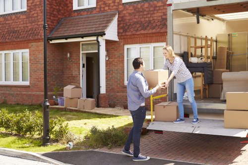 Local moving van collecting household items in Lambeth