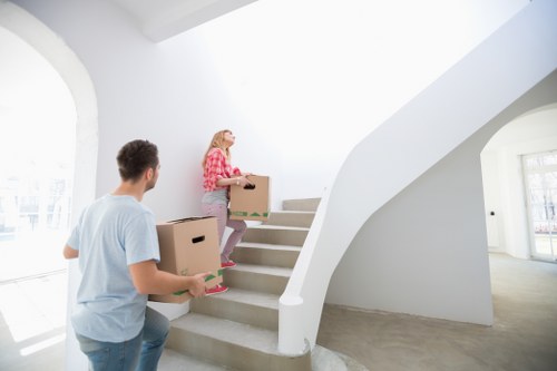 Professional movers carrying furniture in a Lambeth apartment building