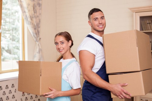 Mover wearing PPE while loading furniture into a van